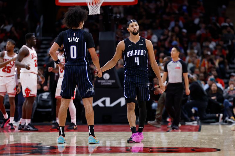 CHICAGO, IL - OCTOBER 30: Jalen Suggs #4 and Anthony Black #0 of the Orlando Magic high five during the game against the Chicago Bulls on October 30, 2024 at United Center in Chicago, Illinois. NOTE TO USER: User expressly acknowledges and agrees that, by downloading and or using this photograph, User is consenting to the terms and conditions of the Getty Images License Agreement. Mandatory Copyright Notice: Copyright 2024 NBAE (Photo by Kamil Krzaczynski/NBAE via Getty Images)