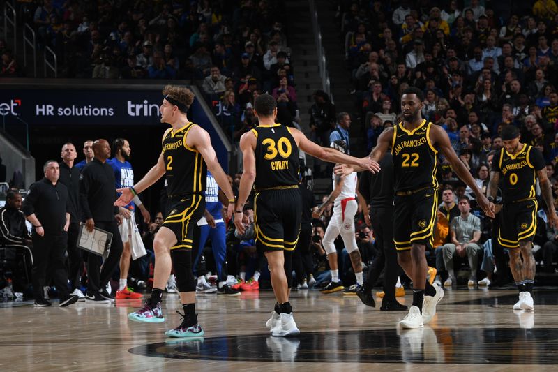 SAN FRANCISCO, CA - FEBRUARY 14: Andrew Wiggins #22 high fives Stephen Curry #30 of the Golden State Warriors during the game against the LA Clippers on FEBRUARY 14, 2024 at Chase Center in San Francisco, California. NOTE TO USER: User expressly acknowledges and agrees that, by downloading and or using this photograph, user is consenting to the terms and conditions of Getty Images License Agreement. Mandatory Copyright Notice: Copyright 2024 NBAE (Photo by Noah Graham/NBAE via Getty Images)