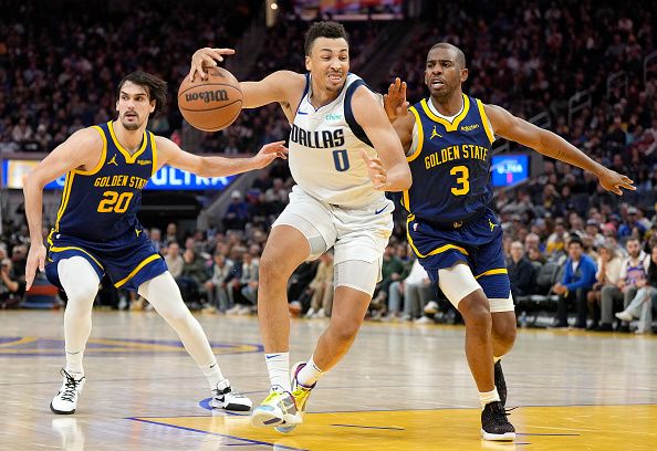 SAN FRANCISCO, CALIFORNIA - DECEMBER 30: Dante Exum #0 of the Dallas Mavericks losing control of the ball gets fouled by Chris Paul #3 of the Golden State Warriors during the fourth quarter of an NBA basketball game at Chase Center on December 30, 2023 in San Francisco, California. NOTE TO USER: User expressly acknowledges and agrees that, by downloading and or using this photograph, User is consenting to the terms and conditions of the Getty Images License Agreement. (Photo by Thearon W. Henderson/Getty Images)