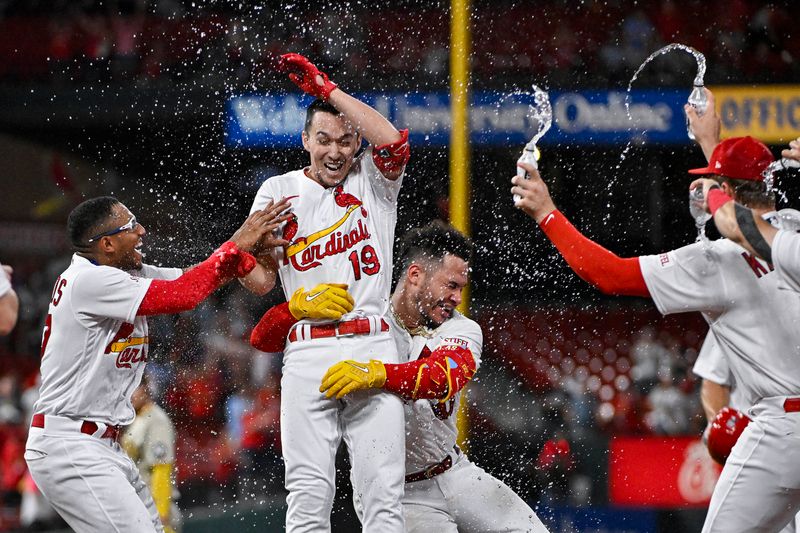 Aug 29, 2023; St. Louis, Missouri, USA;  St. Louis Cardinals pinch hitter Tommy Edman (19) is doused with water as he celebrates with his catcher Willson Contreras (40) center fielder Richie Palacios (67) and teammates after hitting a walk-off one run single against the San Diego Padres during the tenth inning at Busch Stadium. Mandatory Credit: Jeff Curry-USA TODAY Sports