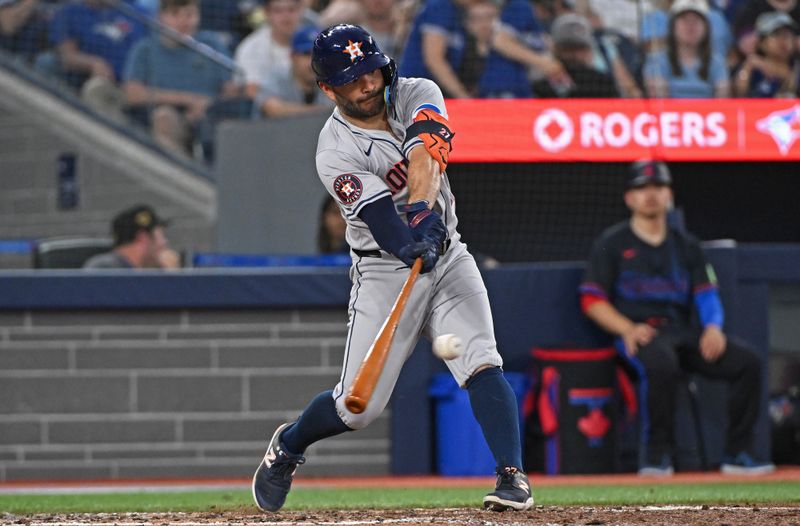 Jul 3, 2024; Toronto, Ontario, CAN; Houston Astros second baseman Jose Altuve (27) hits a RBI single in the seventh inning against the Toronto Blue Jays at Rogers Centre. Mandatory Credit: Gerry Angus-USA TODAY Sports