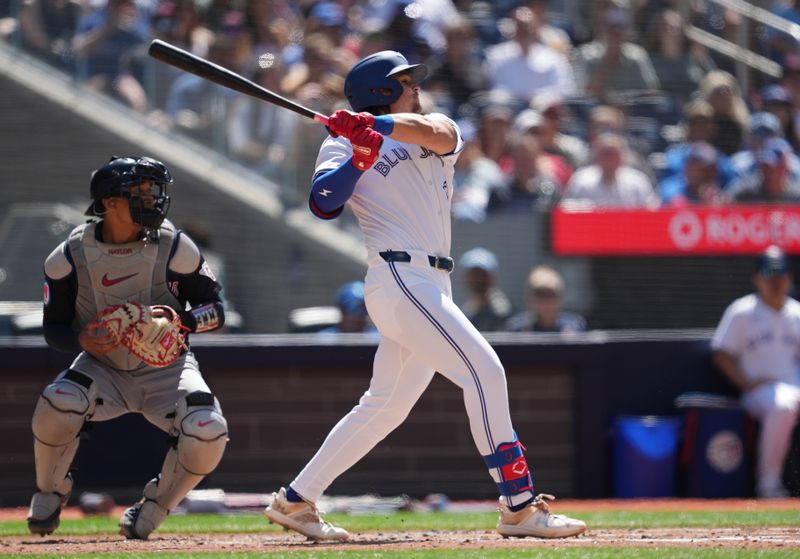 Jun 15, 2024; Toronto, Ontario, CAN; Toronto Blue Jays third baseman Addison Barger (47) hits an RBI single against the Cleveland Guardians during the second inning at Rogers Centre. Mandatory Credit: Nick Turchiaro-USA TODAY Sports