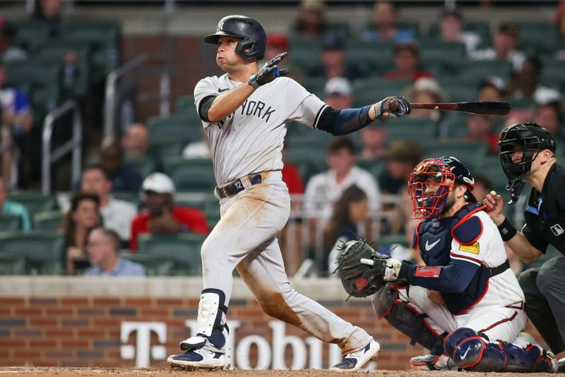 Aug 14, 2023; Atlanta, Georgia, USA; New York Yankees third baseman Isiah Kiner-Falefa (12) hits a single against the Atlanta Braves in the eighth inning at Truist Park. Mandatory Credit: Brett Davis-USA TODAY Sports