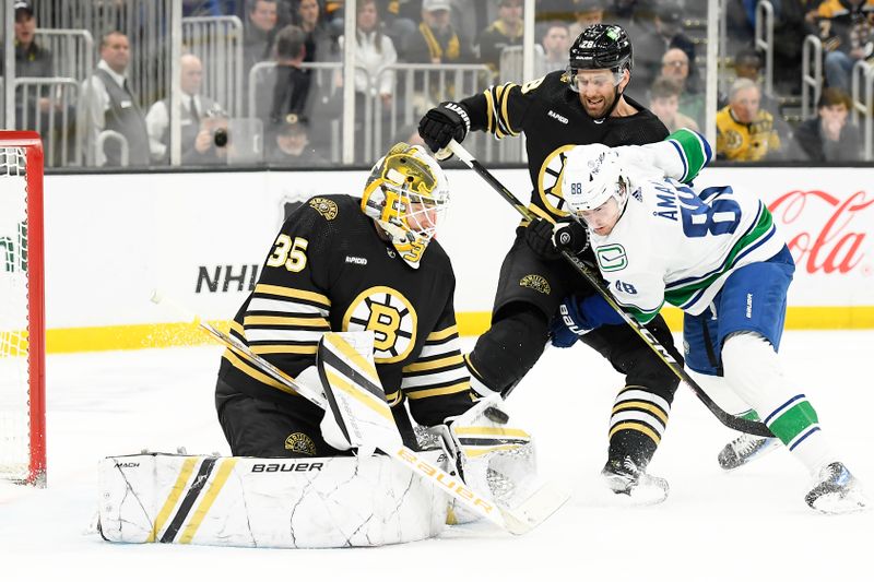 Feb 8, 2024; Boston, Massachusetts, USA; Boston Bruins goaltender Linus Ullmark (35) makes a save in front of Vancouver Canucks center Nils Aman (88) and defenseman Matt Grzelcyk (48) during the second period at TD Garden. Mandatory Credit: Bob DeChiara-USA TODAY Sports