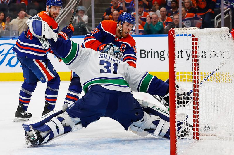 May 12, 2024; Edmonton, Alberta, CAN; Vancouver Canucks goaltender Arturs Silovs (31) makes a save on  on Edmonton Oilers forward Connor McDavid (97) during the third period in game three of the second round of the 2024 Stanley Cup Playoffs at Rogers Place. Mandatory Credit: Perry Nelson-USA TODAY Sports