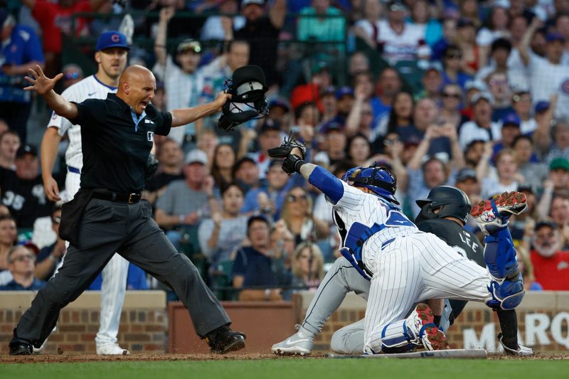 Jun 5, 2024; Chicago, Illinois, USA; Chicago White Sox catcher Korey Lee (26) scores against Chicago Cubs catcher Yan Gomes (15) during the fourth inning at Wrigley Field. Mandatory Credit: Kamil Krzaczynski-USA TODAY Sports