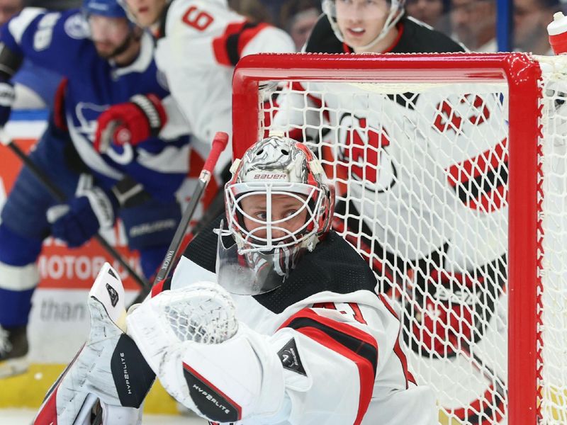 Jan 27, 2024; Tampa, Florida, USA; New Jersey Devils goaltender Vitek Vanecek (41) makes a save against the Tampa Bay Lightning during the first period at Amalie Arena. Mandatory Credit: Kim Klement Neitzel-USA TODAY Sports