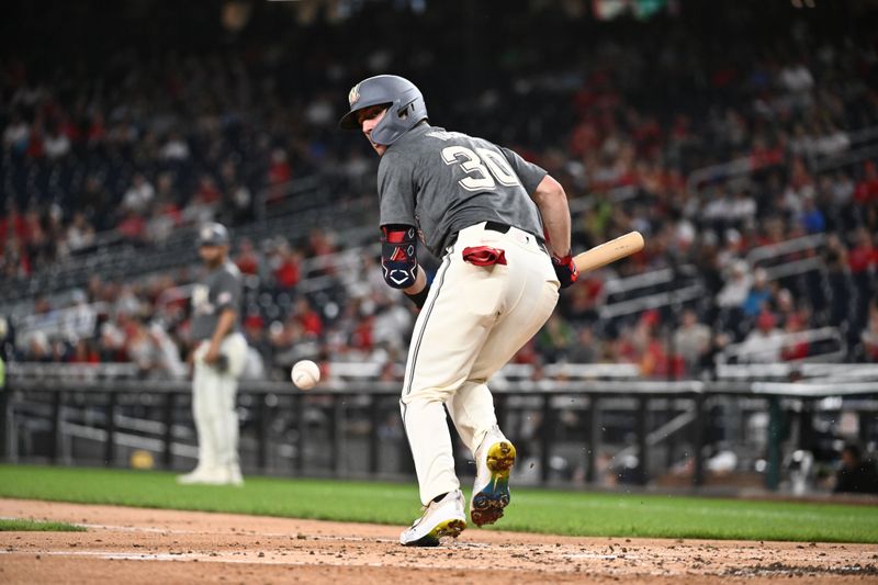 Sep 27, 2024; Washington, District of Columbia, USA;  Washington Nationals outfielder Jacob Young (30) bunts a ball foul during the first inning against the Philadelphia Phillies at Nationals Park. Mandatory Credit: James A. Pittman-Imagn Images
