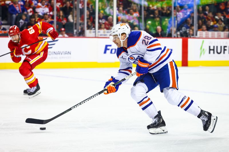 Nov 3, 2024; Calgary, Alberta, CAN; Edmonton Oilers right wing Connor Brown (28) controls the puck against the Calgary Flames during the third period at Scotiabank Saddledome. Mandatory Credit: Sergei Belski-Imagn Images