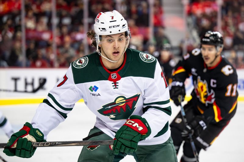 Nov 23, 2024; Calgary, Alberta, CAN; Minnesota Wild defenseman Brock Faber (7) skates against the Calgary Flames during the first period at Scotiabank Saddledome. Mandatory Credit: Brett Holmes-Imagn Images