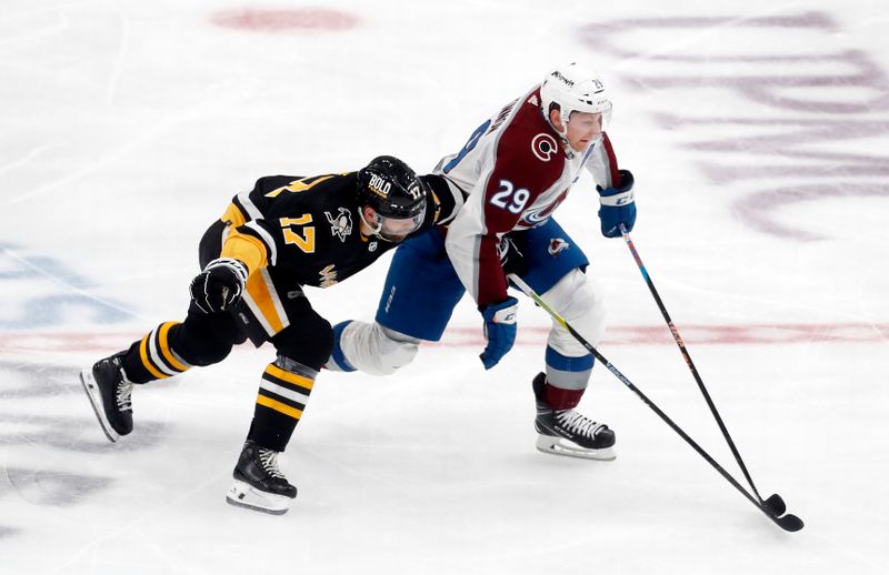 Oct 26, 2023; Pittsburgh, Pennsylvania, USA; Colorado Avalanche center Nathan MacKinnon (29) moves the puck against Pittsburgh Penguins right wing Bryan Rust (17) during the second period at PPG Paints Arena. Mandatory Credit: Charles LeClaire-USA TODAY Sports