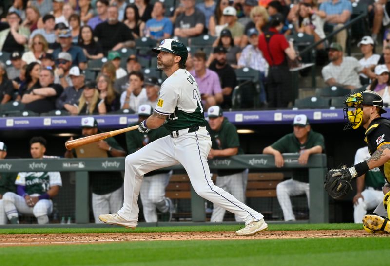 Jun 15, 2024; Denver, Colorado, USA; Colorado Rockies outfielder Jake Cave (11) doubles in the fourth inning against the Pittsburgh Pirates at Coors Field. Mandatory Credit: John Leyba-USA TODAY Sports