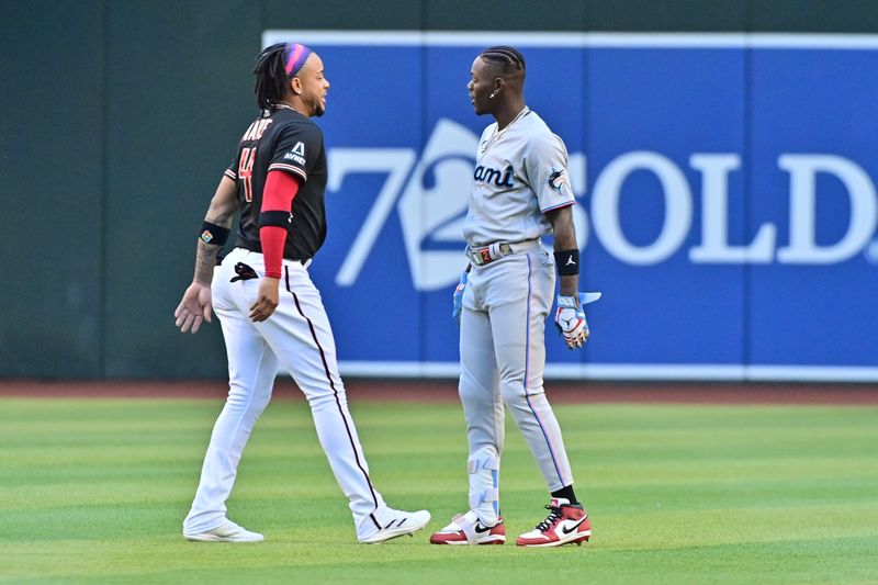 May 8, 2023; Phoenix, Arizona, USA;  Arizona Diamondbacks second baseman Ketel Marte (4) and Miami Marlins center fielder Jazz Chisholm Jr. (2) talk prior to the game at Chase Field. Mandatory Credit: Matt Kartozian-USA TODAY Sports