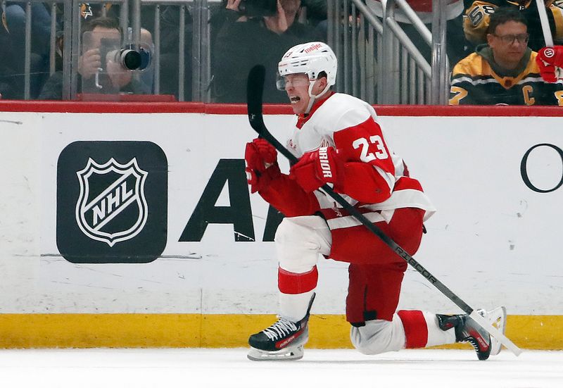 Apr 11, 2024; Pittsburgh, Pennsylvania, USA; Detroit Red Wings left wing Lucas Raymond (23) reacts after scoring a goal to complete a hat-trick against the Pittsburgh Penguins during the third period at PPG Paints Arena. Pittsburgh won 6-5 in overtime. Mandatory Credit: Charles LeClaire-USA TODAY Sports