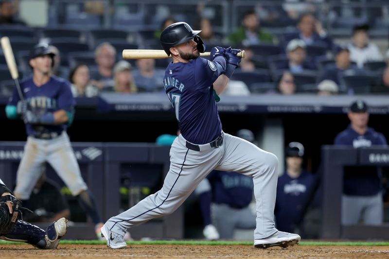 May 20, 2024; Bronx, New York, USA; Seattle Mariners designated hitter Mitch Haniger (17) follows through on an RBI single against the New York Yankees during the ninth inning at Yankee Stadium. Mandatory Credit: Brad Penner-USA TODAY Sports