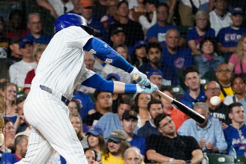 Sep 16, 2024; Chicago, Illinois, USA; Chicago Cubs outfielder Ian Happ (8) hits a one run single against the Oakland Athletics during the second inning at Wrigley Field. Mandatory Credit: David Banks-Imagn Images