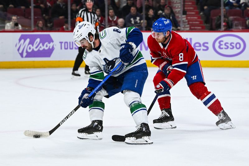 Nov 12, 2023; Montreal, Quebec, CAN; Vancouver Canucks right wing Conor Garland (8) plays the puck against Montreal Canadiens defenseman Mike Matheson (8) during the first period at Bell Centre. Mandatory Credit: David Kirouac-USA TODAY Sports