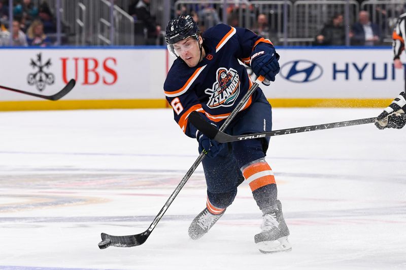 Dec 27, 2022; Elmont, New York, USA; New York Islanders defenseman Ryan Pulock (6) shoots the puck into the zone against the Pittsburgh Penguins during the second period at UBS Arena. Mandatory Credit: Dennis Schneidler-USA TODAY Sports