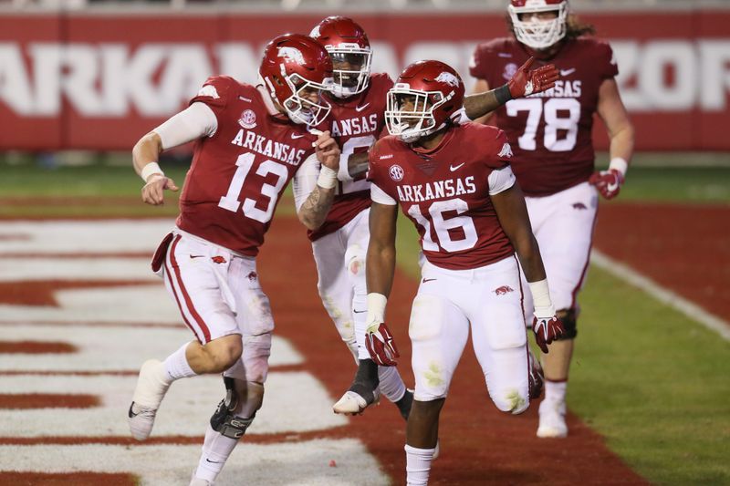 Nov 7, 2020; Fayetteville, Arkansas, USA; Arkansas Razorbacks quarterback Feleipe Franks (13) celebrates with wide receiver Treylon Burks (16) after a touchdown catch by Burks against the Tennessee Volunteers at Donald W. Reynolds Razorback Stadium. Arkansas won 24-13. Mandatory Credit: Nelson Chenault-USA TODAY Sports