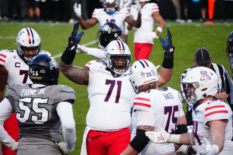 Nov 11, 2023; Boulder, Colorado, USA; Arizona Wildcats offensive lineman Jonah Savaiinaea (71) celebrates defeating the against the Colorado Buffaloes at Folsom Field. Mandatory Credit: Ron Chenoy-USA TODAY Sports