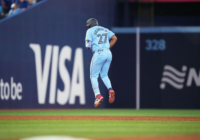 Jul 23, 2024; Toronto, Ontario, CAN; Toronto Blue Jays first base Vladimir Guerrero Jr. (27) runs the bases and celebrates after hitting a home run against the Tampa Bay Rays during the sixth inning at Rogers Centre. Mandatory Credit: Nick Turchiaro-USA TODAY Sports