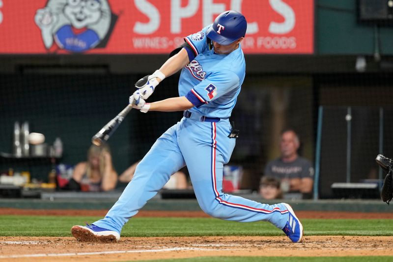 Jun 23, 2024; Arlington, Texas, USA; Texas Rangers shortstop Corey Seager (5) singles against the Kansas City Royals during the sixth inning at Globe Life Field. Mandatory Credit: Jim Cowsert-USA TODAY Sports