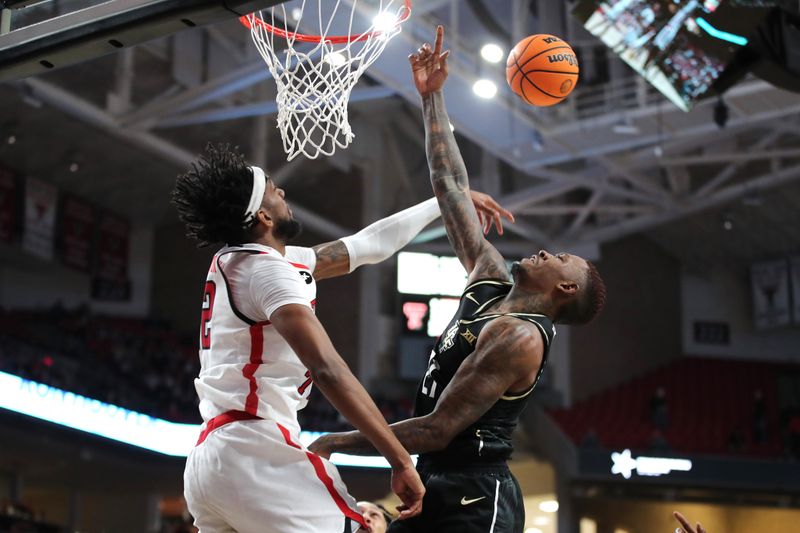 Feb 10, 2024; Lubbock, Texas, USA; Texas Tech Red Raiders forward Warren Washington (22) blocks a shot by Central Florida Knights forward CJ Walker (21) in the first half United Supermarkets Arena. Mandatory Credit: Michael C. Johnson-USA TODAY Sports