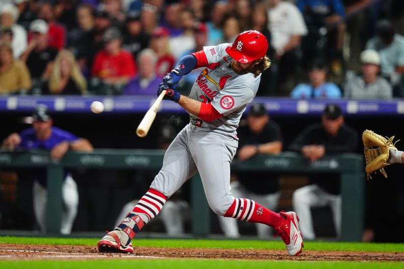 Sep 24, 2024; Denver, Colorado, USA; St. Louis Cardinals outfielder Brendan Donovan (33) singles in the third inning against the Colorado Rockies at Coors Field. Mandatory Credit: Ron Chenoy-Imagn Images