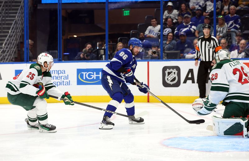 Oct 24, 2024; Tampa, Florida, USA; Tampa Bay Lightning right wing Nikita Kucherov (86) skates with the puck as Minnesota Wild defenseman Jonas Brodin (25) defends during the first period at Amalie Arena. Mandatory Credit: Kim Klement Neitzel-Imagn Images