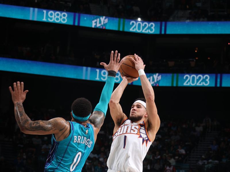 CHARLOTTE, NC - MARCH 15:  Devin Booker #1 of the Phoenix Suns shoots the ball during the game  on March 15, 2024 at Spectrum Center in Charlotte, North Carolina. NOTE TO USER: User expressly acknowledges and agrees that, by downloading and or using this photograph, User is consenting to the terms and conditions of the Getty Images License Agreement.  Mandatory Copyright Notice:  Copyright 2024 NBAE (Photo by Nathaniel S. Butler/NBAE via Getty Images)