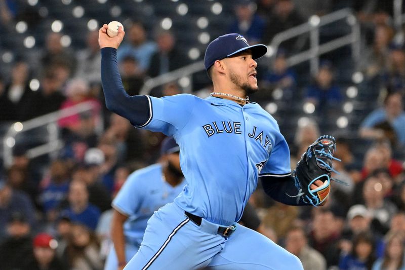 May 1, 2025; Toronto, Ontario, CAN;  Toronto Blue Jays starting pitcher Jose Berrios (17) delivers a pitch against the Boston Red Sox in the first inning at Rogers Centre. Mandatory Credit: Dan Hamilton-Imagn Images