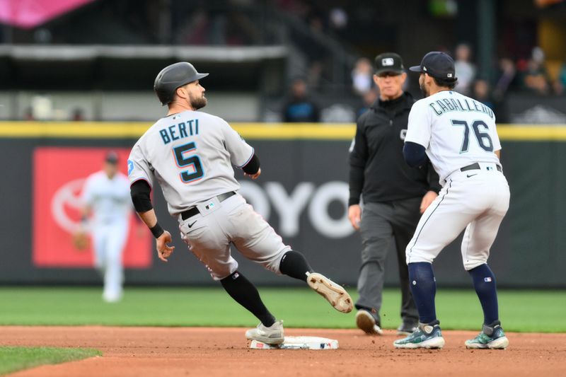 Jun 14, 2023; Seattle, Washington, USA; Miami Marlins shortstop Jon Berti (5) touches first base before being called out during a double play against the Seattle Mariners during the fifth inning at T-Mobile Park. Mandatory Credit: Steven Bisig-USA TODAY Sports