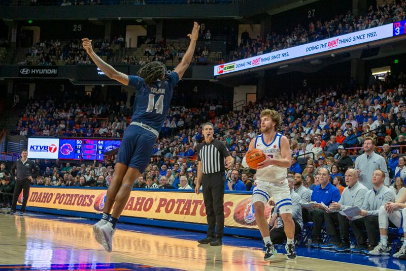 Jan 17, 2023; Boise, Idaho, USA; Nevada Wolf Pack forward Tre Coleman (14) defends against Boise State Broncos guard Max Rice (12) during the second half at ExtraMile Arena. Boise State defeats Nevada 77-62. Mandatory Credit: Brian Losness-USA TODAY Sports