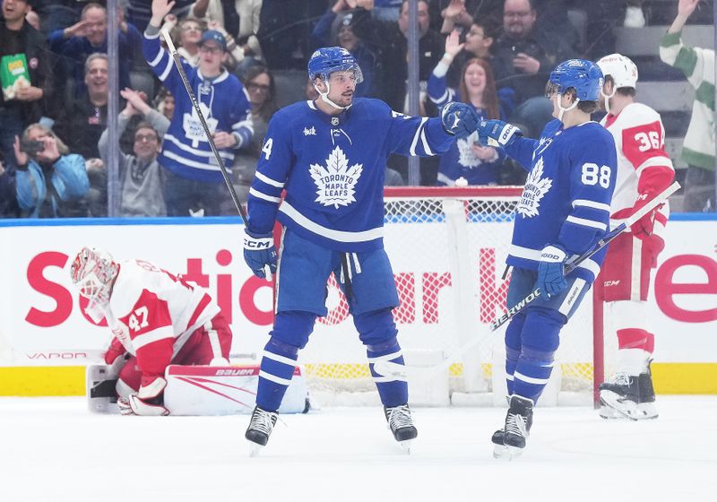 Apr 13, 2024; Toronto, Ontario, CAN; Toronto Maple Leafs center Auston Matthews (34) scores his 69th goal of the season and celebrates with right wing William Nylander (88) against the Detroit Red Wings during the second period at Scotiabank Arena. Mandatory Credit: Nick Turchiaro-USA TODAY Sports