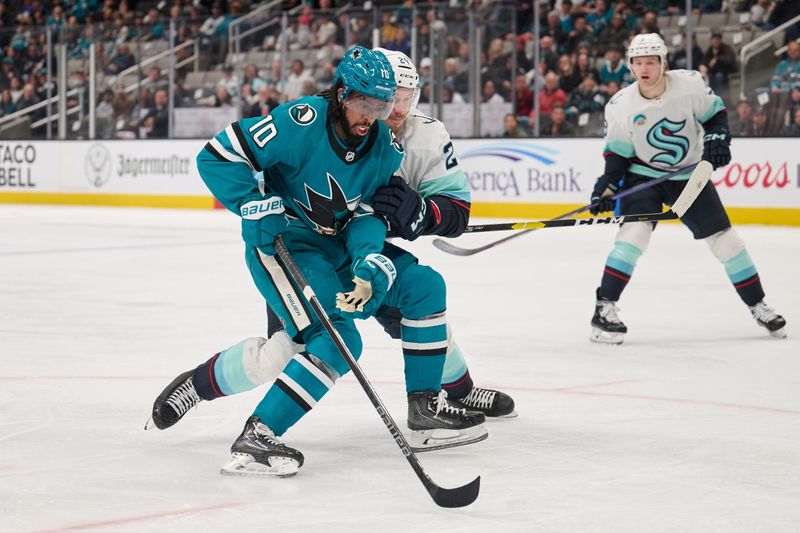 Jan 30, 2024; San Jose, California, USA; San Jose Sharks left wing Anthony Duclair (10) defends the puck against Seattle Kraken defenseman Jamie Oleksiak (24) during the second period at SAP Center at San Jose. Mandatory Credit: Robert Edwards-USA TODAY Sports