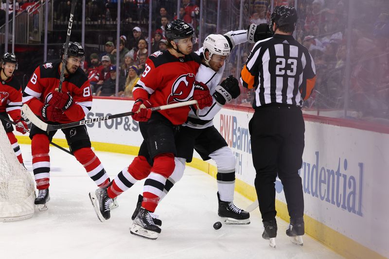 Feb 23, 2023; Newark, New Jersey, USA; New Jersey Devils defenseman Damon Severson (28) hits Los Angeles Kings right wing Gabriel Vilardi (13) during the third period at Prudential Center. Mandatory Credit: Ed Mulholland-USA TODAY Sports