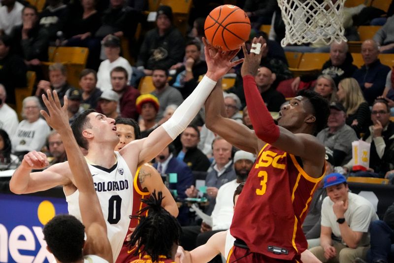 Feb 23, 2023; Boulder, Colorado, USA; USC Trojans forward VIncent Iwuchukwu (3) and Colorado Buffaloes guard Luke O'Brien (0) reach for a loose ball in the first half at the CU Events Center. Mandatory Credit: Ron Chenoy-USA TODAY Sports