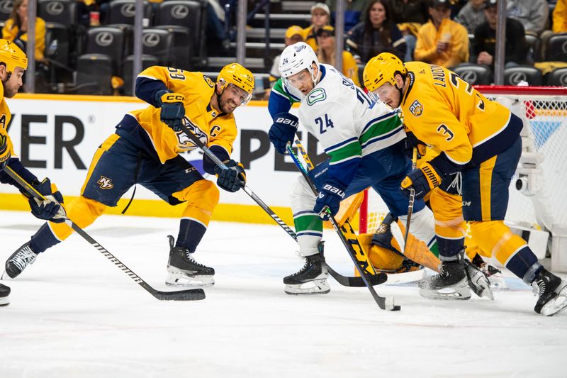 May 3, 2024; Nashville, Tennessee, USA; Nashville Predators defenseman Jeremy Lauzon (3) blocks the shot of Vancouver Canucks center Pius Suter (24) during the second period in game six of the first round of the 2024 Stanley Cup Playoffs at Bridgestone Arena. Mandatory Credit: Steve Roberts-USA TODAY Sports