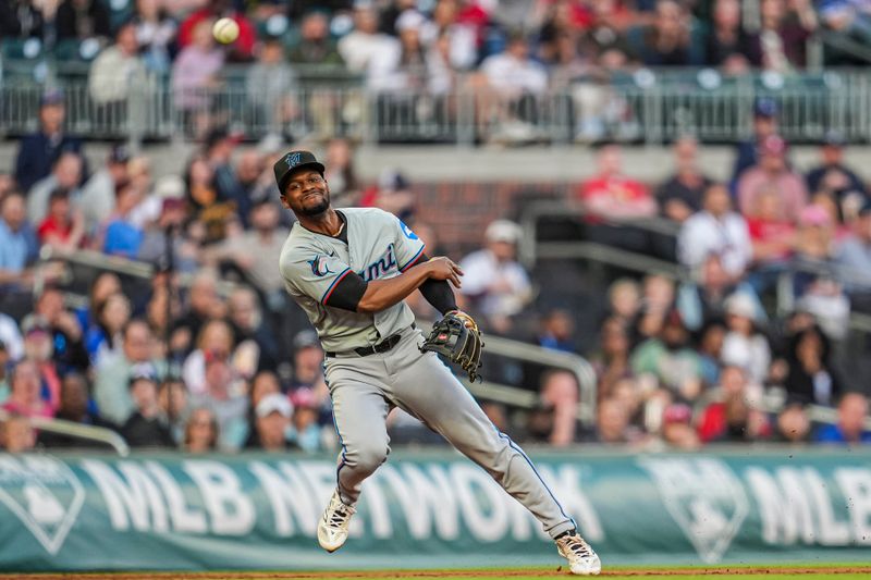 Apr 23, 2024; Cumberland, Georgia, USA; Miami Marlins third base Otto Lopez (61) throws after committing a fielding error against the Atlanta Braves during the first inning at Truist Park. Mandatory Credit: Dale Zanine-USA TODAY Sports