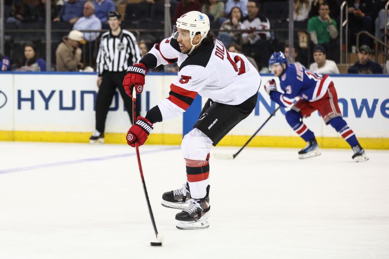 Mar 18, 2026; New York, New York, USA;  New Jersey Devils defenseman Brenden Dillon (5) controls the puck in the third period against the New York Rangers at Madison Square Garden. Mandatory Credit: Wendell Cruz-Imagn Images