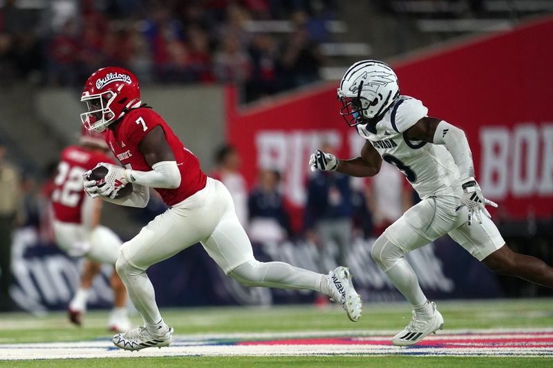 Sep 30, 2023; Fresno, California, USA; Fresno State Bulldogs linebacker Morice Norris Jr. (7) runs with the ball after intercepting a pass in front of Nevada Wolf Pack wide receiver Jamaal Bell (3) in the fourth quarter at Valley Children's Stadium. Mandatory Credit: Cary Edmondson-USA TODAY Sports