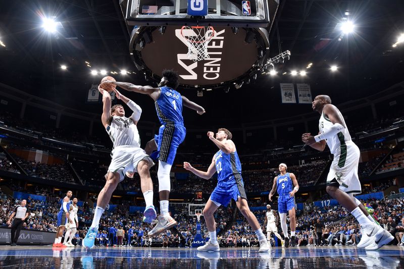 ORLANDO, FL - APRIL 14: Jonathan Isaac #1 of the Orlando Magic blocks the shot of Brook Lopez #11 of the Milwaukee Bucks on April 14, 2024 at Kia Center in Orlando, Florida. NOTE TO USER: User expressly acknowledges and agrees that, by downloading and or using this photograph, User is consenting to the terms and conditions of the Getty Images License Agreement. Mandatory Copyright Notice: Copyright 2024 NBAE (Photo by Fernando Medina/NBAE via Getty Images)