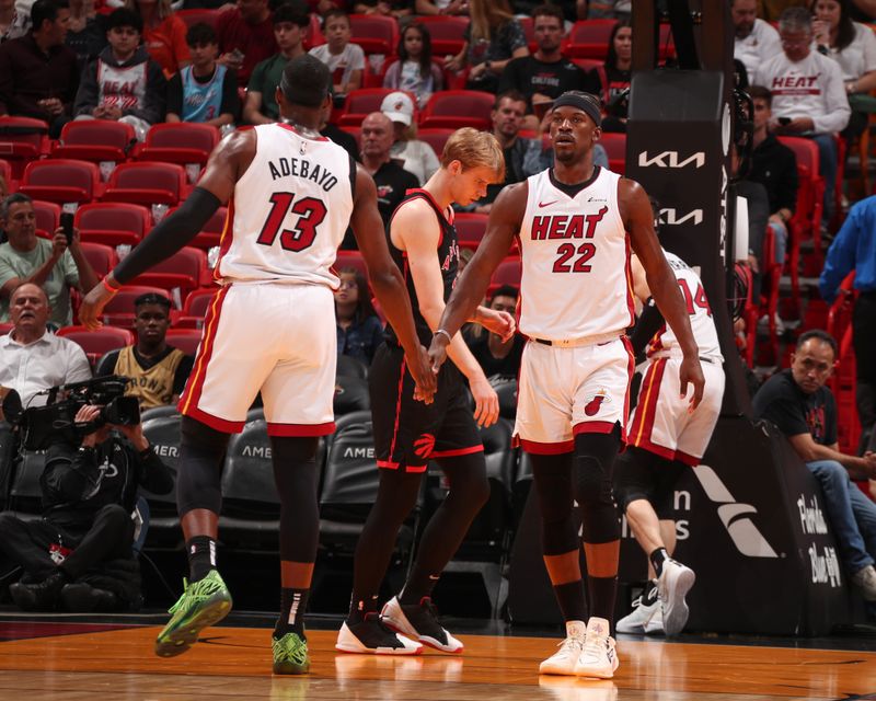 MIAMI, FL - APRIL 14:  Bam Adebayo #13 of the Miami Heat & Jimmy Butler #22 of the Miami Heat high five during the game on April 14, 2024 at Kaseya Center in Miami, Florida. NOTE TO USER: User expressly acknowledges and agrees that, by downloading and or using this Photograph, user is consenting to the terms and conditions of the Getty Images License Agreement. Mandatory Copyright Notice: Copyright 2024 NBAE (Photo by Issac Baldizon/NBAE via Getty Images)