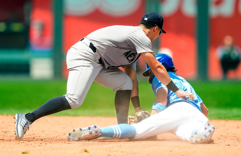 Jun 13, 2024; Kansas City, Missouri, USA; Kansas City Royals shortstop Bobby Witt Jr. (7) is caught stealing second base by New York Yankees second baseman Gleyber Torres (25) during the sixth inning at Kauffman Stadium. Mandatory Credit: Jay Biggerstaff-USA TODAY Sports