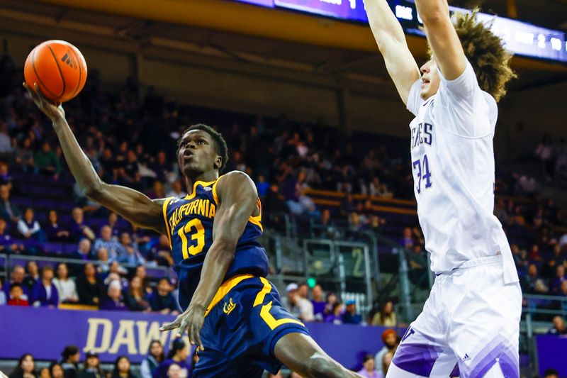 Jan 14, 2023; Seattle, Washington, USA; California Golden Bears forward Kuany Kuany (13) shoots a layup against Washington Huskies center Braxton Meah (34) during the first half at Alaska Airlines Arena at Hec Edmundson Pavilion. Mandatory Credit: Joe Nicholson-USA TODAY Sports