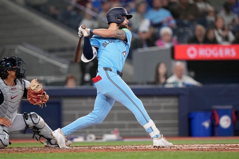 May 4, 2025; Toronto, Ontario, CAN; Toronto Blue Jays center fielder Nathan Lukes (38) hits an RBI double against the Cleveland Guardians during the fourth inning at Rogers Centre. Mandatory Credit: John E. Sokolowski-Imagn Images