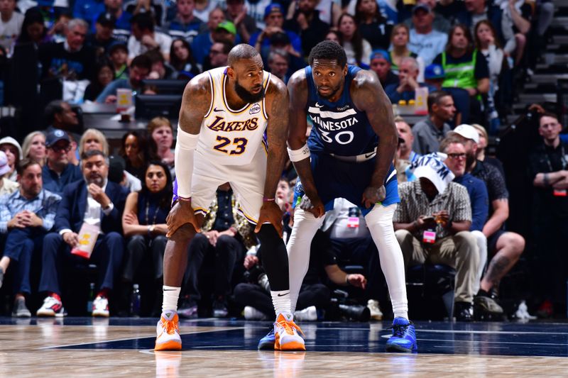 MINNEAPOLIS, MN -  APRIL 27: LeBron James #23 of the Los Angeles Lakers and Julius Randle #30 of the Minnesota Timberwolves look on during the game during Round 1 Game 4 of the 2025 NBA Playoffs on April 27, 2025 at Target Center in Minneapolis, Minnesota. NOTE TO USER: User expressly acknowledges and agrees that, by downloading and or using this Photograph, user is consenting to the terms and conditions of the Getty Images License Agreement. Mandatory Copyright Notice: Copyright 2025 NBAE (Photo by Barry Gossage/NBAE via Getty Images)