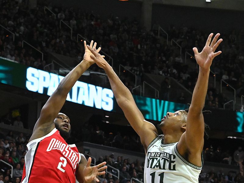 Feb 25, 2024; East Lansing, Michigan, USA;  Ohio State Buckeyes guard Bruce Thornton (2) tries a shot past Michigan State Spartans guard A.J. Hoggard (11) during the first half at Jack Breslin Student Events Center. Mandatory Credit: Dale Young-USA TODAY Sports