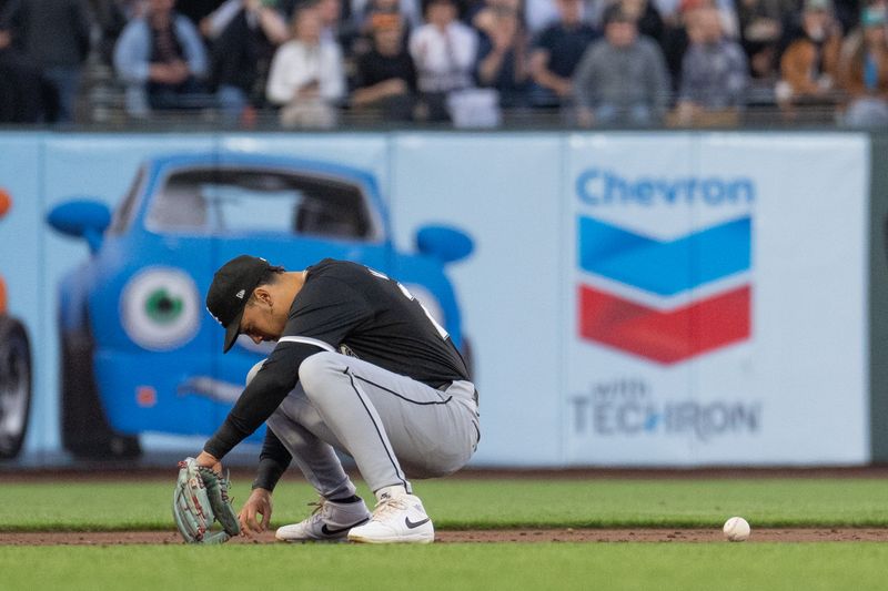 Aug 20, 2024; San Francisco, California, USA;  Chicago White Sox outfielder Miguel Vargas (20) mishandles the ball during the third inning against the San Francisco Giants at Oracle Park. Mandatory Credit: Stan Szeto-USA TODAY Sports