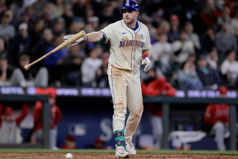 Jun 2, 2024; Seattle, Washington, USA; Seattle Mariners left fielder Luke Raley (20) tosses his bat after he was hit by a pitch with the bases loaded scoring a run against the Los Angeles Angels during the eighth inning at T-Mobile Park. Mandatory Credit: John Froschauer-USA TODAY Sports